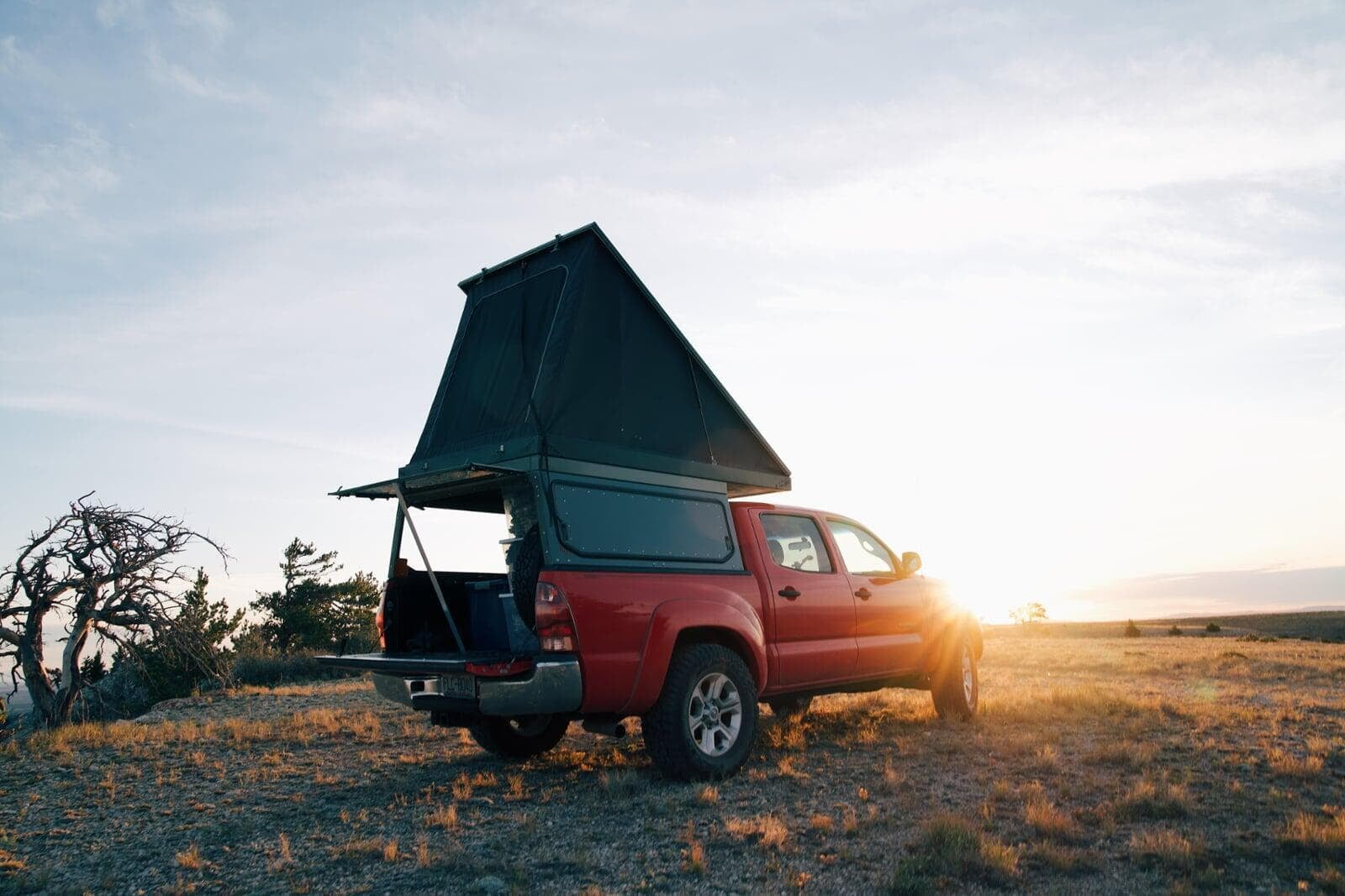 Red truck rear view with pop-up camper mounted on bed
